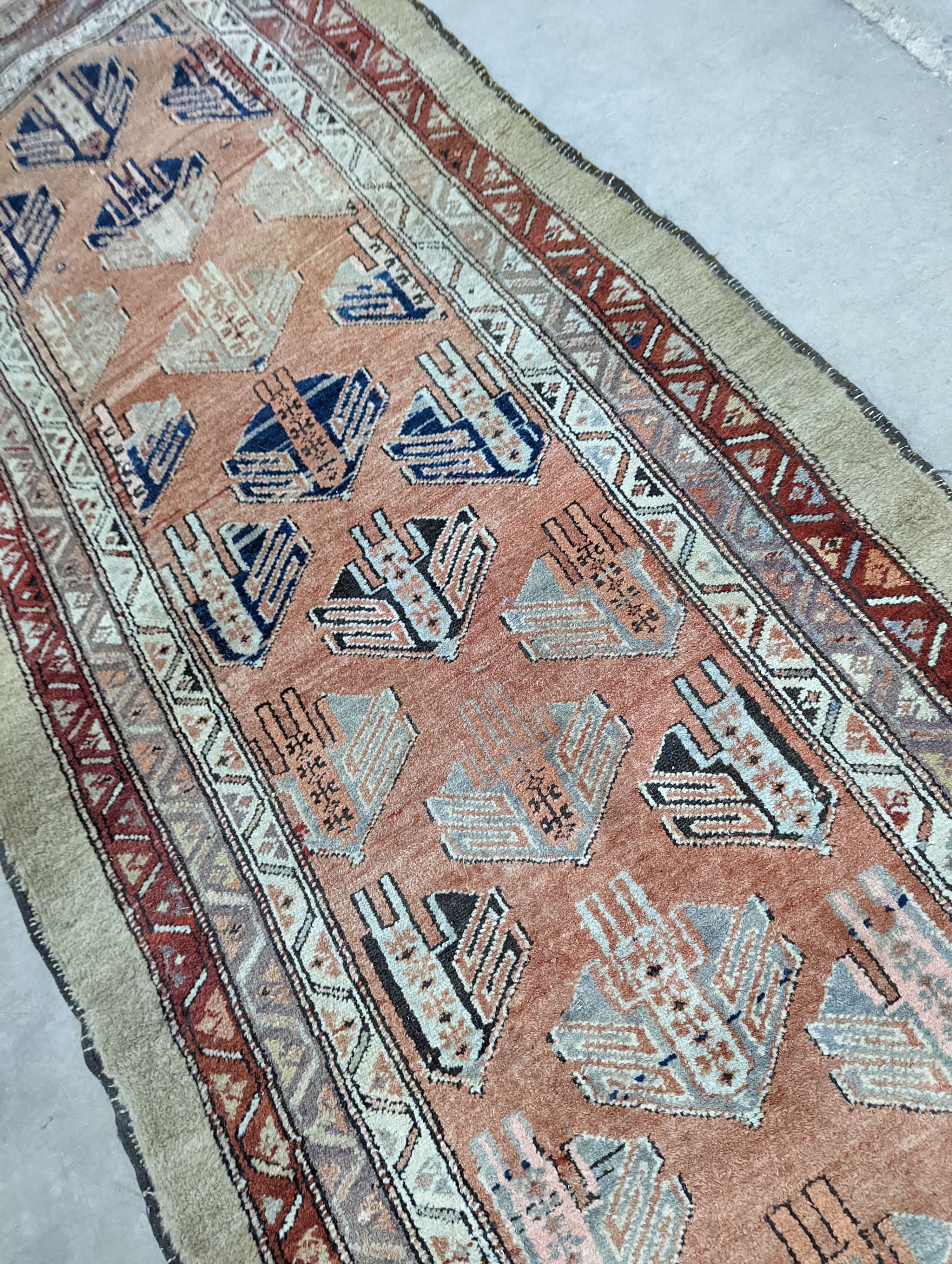 An Afghan brick red ground geometric runner and a smaller Afghan rug, larger 306 x 106cm